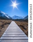 Small photo of Sun burst over Mount Cook view feon wooden trek