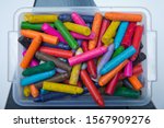Small photo of Wax color crayons all messed up . Crayons on the table. Montessori wood color gamut . crayon and paper photos on the table, colorful theme backgrounds, drawing theme wallpapers. Plastic box