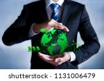 Businessman with a green globe. eco-friendly business. Business and environmental concepts