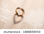 Two Wedding Rings On The Book...