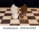 Small photo of Two chess knights are facing each other on the chessboard. The concept of rivalry, duel, battle, struggle, two opposing sides, enemies, opposition, enmity.