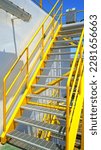 Small photo of yellow iron ladder that is synonymous with stairs in offshore locations