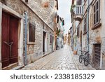 Medieval street in the city of Rovinj, old houses without restoration, pavement