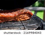 Small photo of SMOKER BBQ FILLED WITH MEAT.Pork belly or Belly Pork is a boneless and fatty cut of meat from the belly of a pig. Pork belly is particularly popular in Hispanic, Chinese, Danish, Norwegia