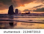 Sunset at Canon beach on the Oregon coast with the sea stack  "the needles"