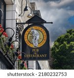 Small photo of Victoria, British Columbia, Canada- 7-10-2022:: A hanging outdoor sign advertising the Sticky Wicket Pub and Reastaurant in Victoria, British Columbia, Canada