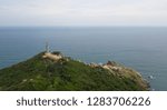 Small photo of Aerial view of Dai Lanh beach and Mui Dien light house in sunny day, MuiDien, Phu Yen province - The eastermost of Vietnam. Stock photo image top view of Mui Dien lighthouse on fractured rocky cliff