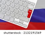 White computer keyboard and red button with word Fake on Russia flag backgroun. Fake news in Russia. War Information Technology