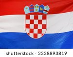 Fabric texture flag of Croatia. Flag of Croatia waving in the wind. Flag of Croatia is depicted on a sports cloth fabric with many folds. Sport team banner