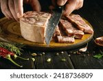 Small photo of Cooking meat snacks with the hands of a chef on the kitchen table. The concept of preparing a delicious snack from brawn.
