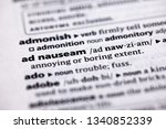 Small photo of Blurred close up to the partial dictionary definition of Ad Nauseam