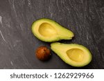 Small photo of Top view of an avocado cut in two with a stone.