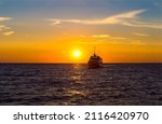 A Ship At Sunset On The Sea...