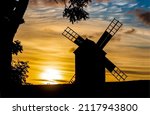 The silhouette of a windmill at ...