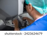 Small photo of Surgeon performing robotic surgery with robotic device. Surgeon using a robotic surgical system to facilitate complex surgery. preparation for performing robotic surgery, doctor's hands.