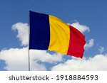 Chad flag isolated on the blue sky with clipping path. close up waving flag of Chad. flag symbols of Chad.