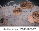 Pile of bitcoins on russia in world map. concept of crypto currency and economic crisis.