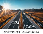 Small photo of Driving on open road at beautiful sunny day to new year 2024. Aerial view