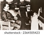 Small photo of Istanbul, Turkey - September17, 2023:Ataturk with his adopted daughter Ulku at the blackboard.1930s