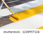 Application Of Road Markings For Pedestrians With Bright Yellow And White Paints. Pedestrian Crossing Over Road. Road Works.