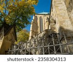 Small photo of Exterior view of the side aisle of Erfurt Cathedral in oblique plane with staircase and metal fence in the foregroundin sunny weather and cloudless sky