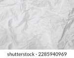 Small photo of Wrinkled or crumpled white stencil paper or tissue after use in toilet or restroom with large copy space is used for background texture in art work.