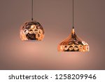 Small photo of Modern streamlined mirror copper chandelier. Bubble metal copper shade pendant.