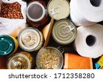 Small photo of Close up of non-perishable food, canned goods and toilet paper. Overhead view.