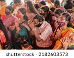 Small photo of Howrah, West Bengal, India - 14th October 2021 : Hindu devotees offering pushpanjali to Goddess Durga, ritual to worship the Goddess with flowers.