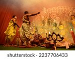Small photo of Howrah, West Bengal, India - 13th October 2021 : Goddess Durga is being worshipped by Hindu priests with holy panchapradip, in forground, during ashtami puja with holy smoke inside puja pandal.