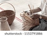 Small photo of man makes a basketwork with finished basketworks