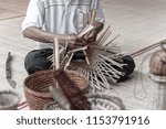 Small photo of man makes a basketwork with finished basketworks