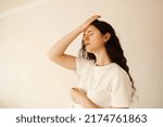 Small photo of Migraine is a strong headache of woman. Overstressed woman touches her head because of pain. Depression of attractive girl