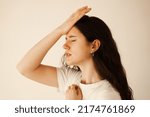 Small photo of Migraine is a strong headache of woman. Overstressed woman touches her head because of pain. Depression of attractive girl