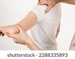 Small photo of Movement assessment or shoulder joint mobilization. Muscle release. Orthopedic traumatologist examines shoulder joint of patient and checks mobility of movements on white background