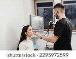 Small photo of ENT doctor using fibrolaryngoscope to examine and treat the ears. ENT specialist diagnoses and treats larynx and pharynx, such as hoarseness, vocal cord nodules, tumors, infections, and inflammation