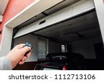 Garage door PVC. Hand use remote controller for closing and opening garage door.
