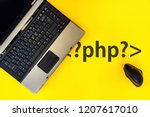 PHP programming language,. laptop and vertical mouse on yellow background with php tag