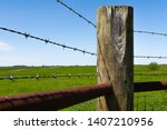 Wooden Post And Barbed Wire...