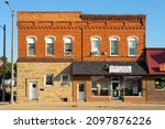 Small photo of Plano, Illinois - United States - September 18th, 2021: Old downtown building in the morning light.