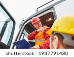 Small photo of Truck drivers from the haulage company and construction workers on the road construction site