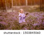 Little girl iw walking in the purple field