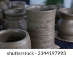 Small photo of Raw clay pot, unblemished and waiting for transformation, ready to undergo the alchemical process of baking and emerge as a functional work of art.