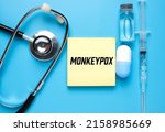 Small photo of A picture of notepad written monkeypox, stethoscope ,medicine and vaccine. Monkeypox is virus transmitted to humans from animals with symptoms very similar to smallpox.