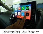 Small photo of "Rimbayu, Malaysia- July 5, 2023: Selective focus with noise effect of finger choosing Netflix at car Android Infotainment Player used in B Segment Sedan car."
