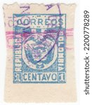Small photo of COLOMBIA - 1901: an original 1 centavo black postage stamp showing Coat of Arms with Rose Overprint