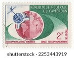Small photo of CAMEROUN (Kamerun) — 1963 February 9: An 2 francs dark blue, claret and green postage stamp depicting Telstar and Globe.1st TV connection of the US and Europe through the Telstar satellite