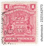Small photo of RHODESIA - 1898: An 1 pence rose postage stamp depicting Arms of the British South Africa Company. BSAC or BSACo was founded in 1889 with the support of the British Government