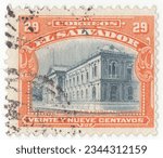 Small photo of EL SALVADOR — 1912: 29 centavo orange and slate postage stamp depicting the National Palace of El Salvador in San Salvador by engineer Jose Emilio Alcaine, under the direction of Pascasio Erazo