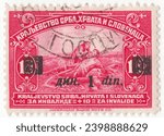 Small photo of YUGOSLAVIA - 1922: 1 dinar on 10 paras carmine postage stamp depicting Giving Succor to Wounded. On the battlefield, a girl bent over a wounded soldier to give him first aid. Surcharged in Black